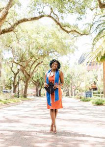 Zyreshia Jackson holding graduation cap