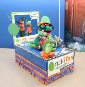 IFAS Communication shoebox parade float that reads "Ask IFAS, powered by EDIS" with various gators