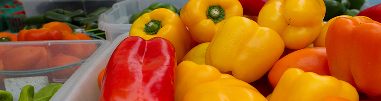 Fresh yellow, red, and orange peppers at the farmers market.