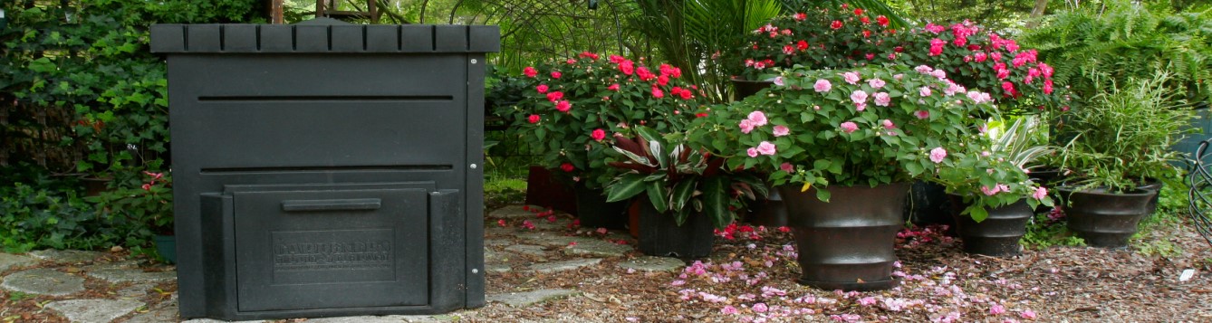 Backyard composter, flowers in pots, trees in background. UF/IFAS Photo: Thomas Wright
