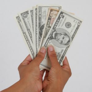 hands holding cash