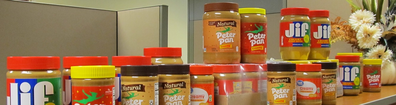 A line of peanut butter jars along countertop