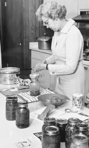A woman canning in the kitchen.