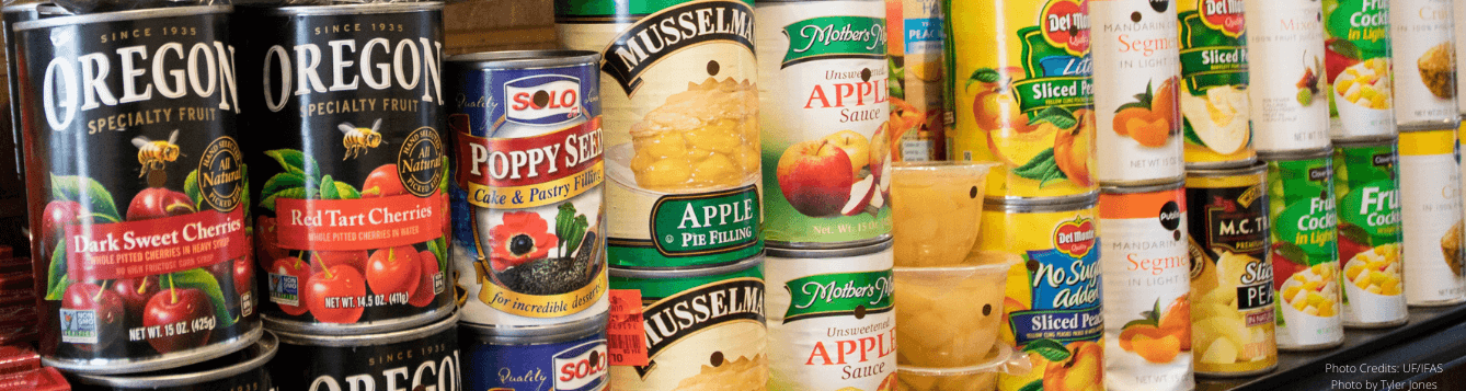 Stacked canned foods on a shelf.