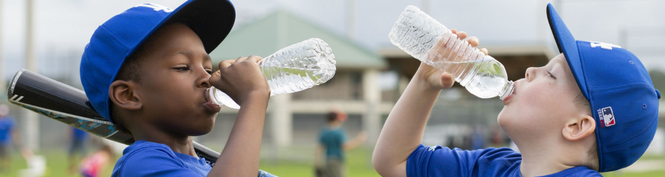Young Baseball Players Drinking Water