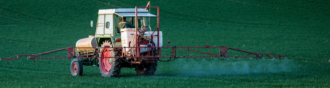 herbicide application from a tractor with boom sprayer