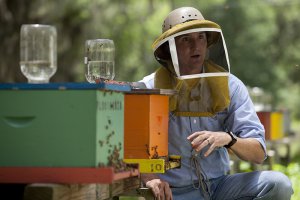 Jamie Ellis demonstrating beekeeping
