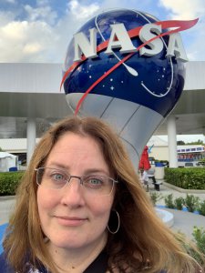 Kelly Rice in front of NASA sign