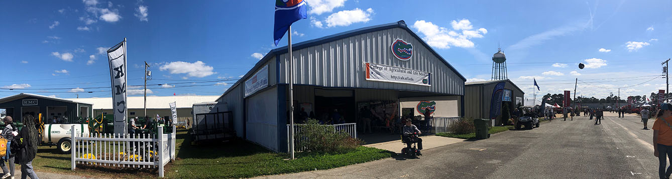 warehouse building on Sunbelt ag expo grounds, blue roof with a flag with the Florida Gators logo