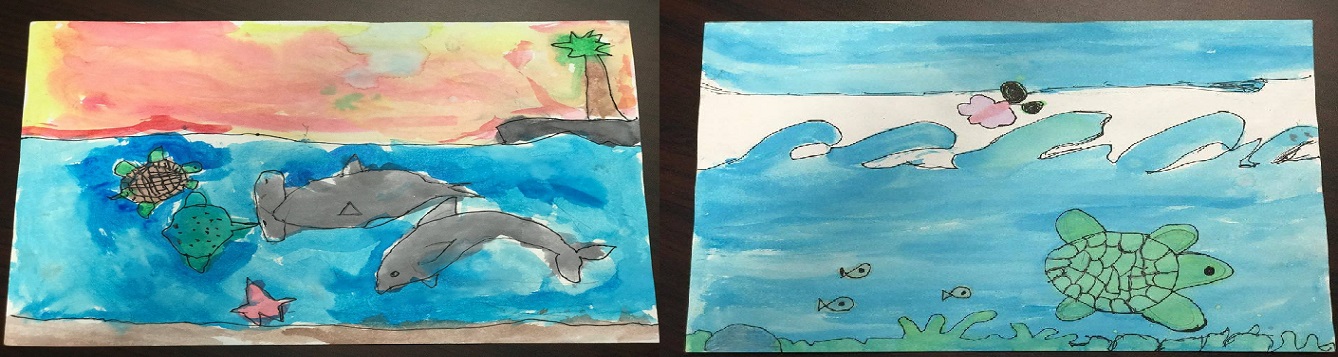 Two children drawings, one of dolphins and an island with a palm tree. The other is of a sea turtle and fish.