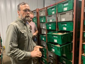 Dr. Ken Pecota standing by organized bins