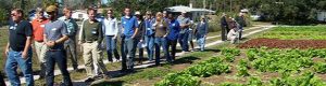 Participants in a "Know Your Farmer, Know Your Farm" meeting tour an area operation.
