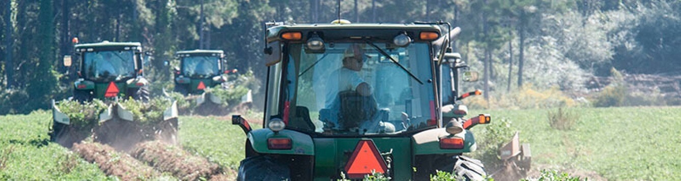 Agriculture equipment operators work in a field. [CREDIT: U.S. Dept. of Agriculture]