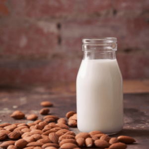 Almond milk surrounded by almonds