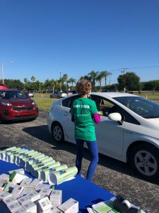 Energy Coach Lake Garren giving out efficiency devices at an All Faiths Food Bank drive-thru event.