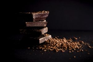 A stack of dark chocolate bars, with a trail of chocolate scrapings. [CREDIT: Pixabay.com]