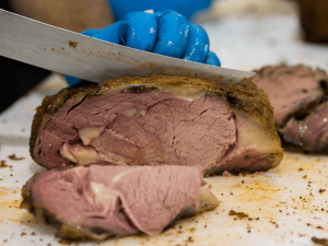 A knife carves through a slab of cooked prime rib. [CREDIT: UF/IFAS, Tyler Jones]