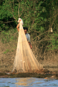 Man fishing with net in Cambodia.