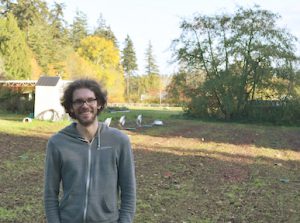 scientist standing in front of farm plot