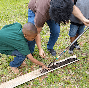 teacher and student making soil profile