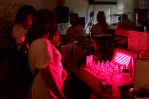 Students in a lab with red lights.