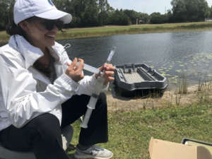 college student with water sampling equipment