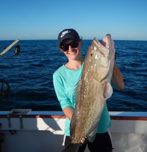 Courtney holding a grouper on an offshore sampling trip