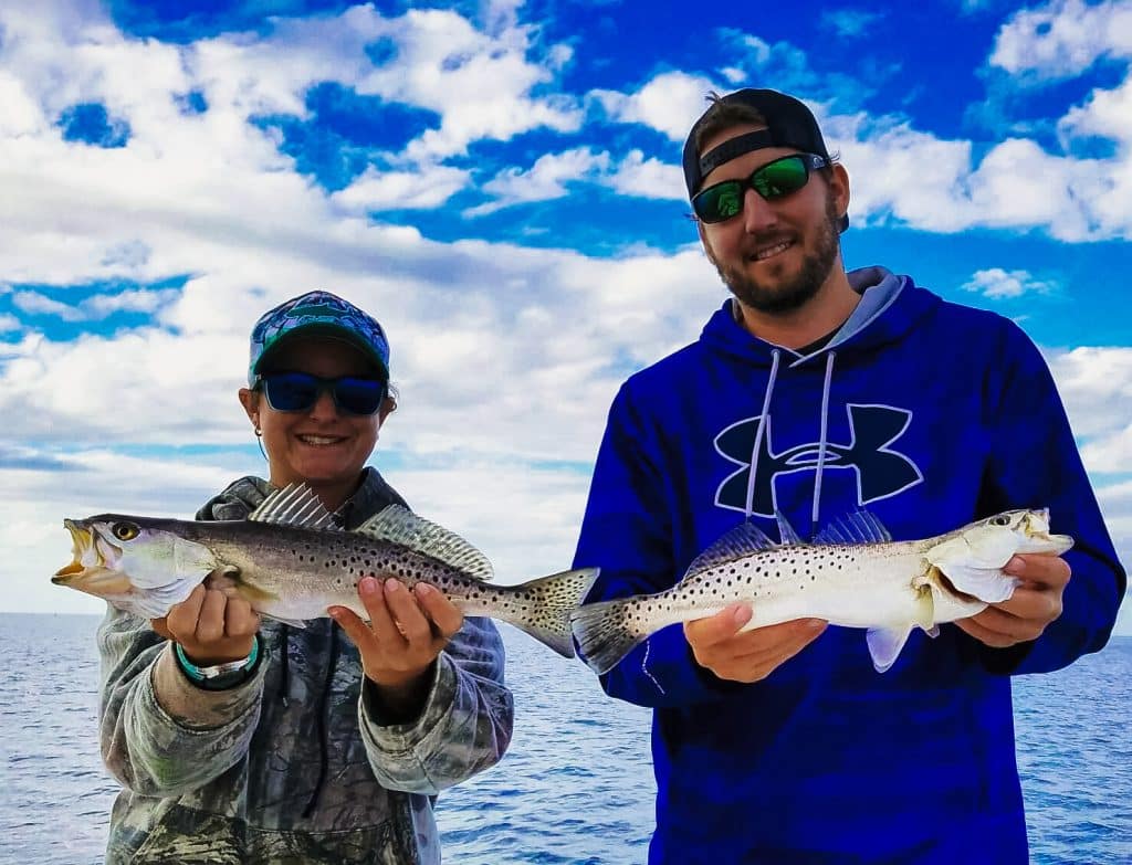 two anglers show off their seatrout catch