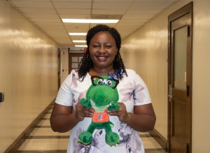 Female student holding gator award