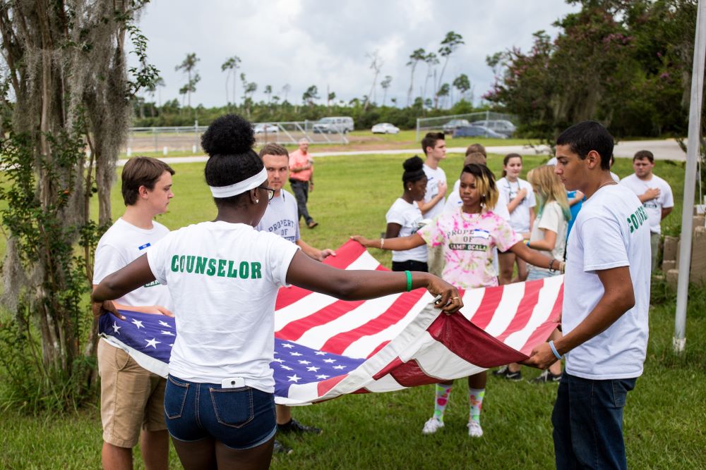 4-H youth volunteers folding a flag