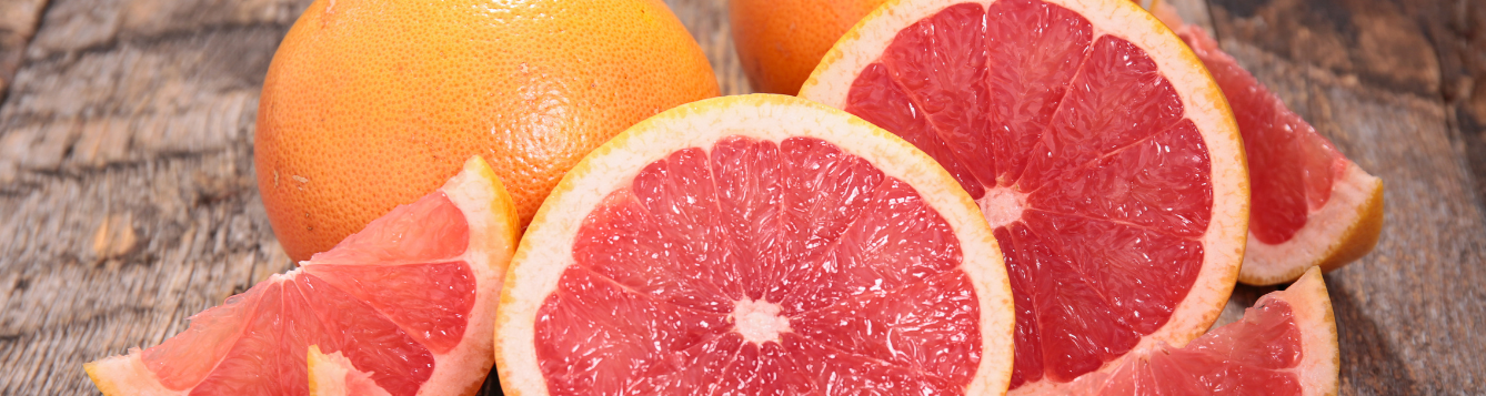 Sliced and whole grapefruits