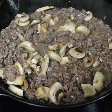 ground beef and mushrooms in skillet