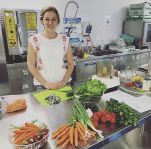 college student young woman in kitchen with seasonal vegetables