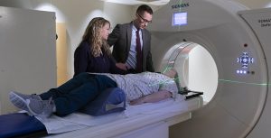 Dr. Jeffrey Brower and Tech Nicole Rae working in Simulator with "patient" Melissa Johnson.