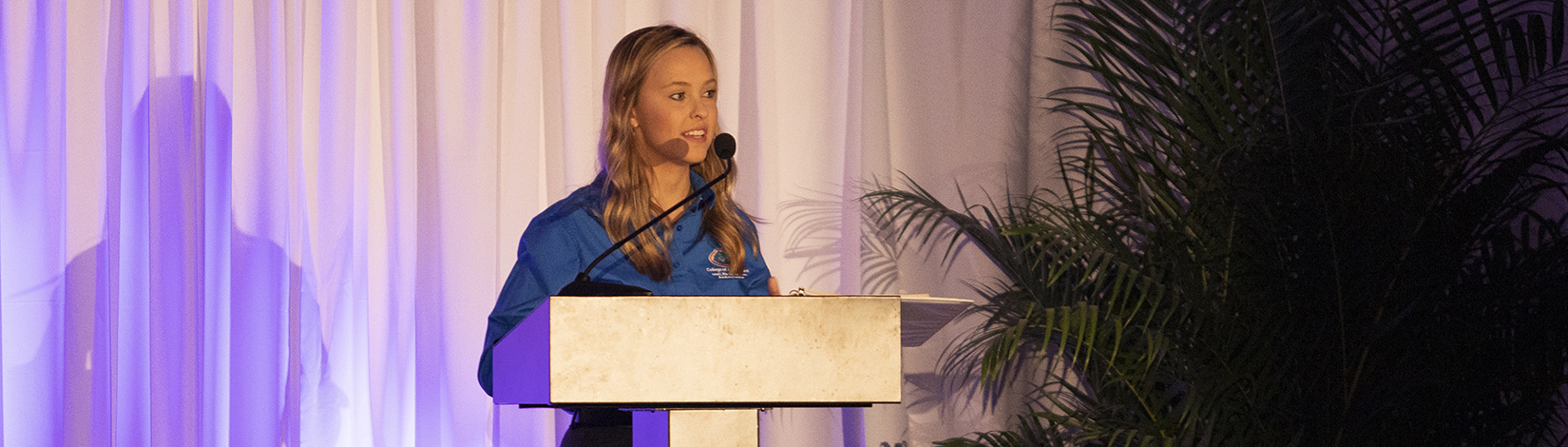 Elanie Mason speaking at an award ceremony.