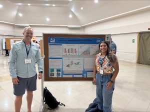 student and mentor with research poster