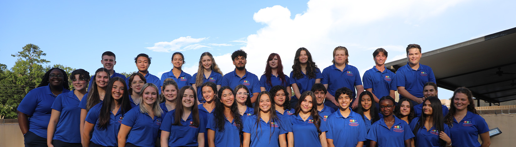Florida Youth Institute participants in blue polos and navy pants posing for a group photo