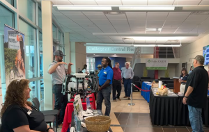 men and women in lobby with agriculture information