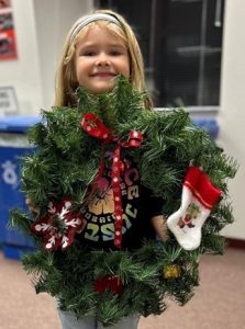 young girl with holiday wreath