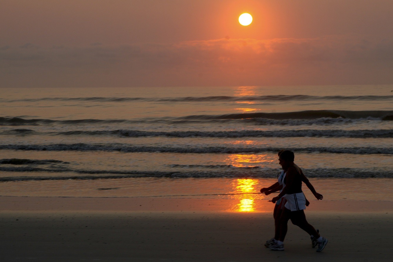 people on beach at sunset