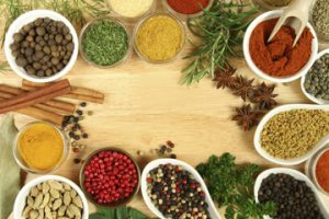 colorful arrangement of herbs and spices, ground and whole