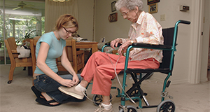 Elderly person receiving assistance from a caregiver with everyday tasks. UF/IFAS Photo by Marisol Amador.