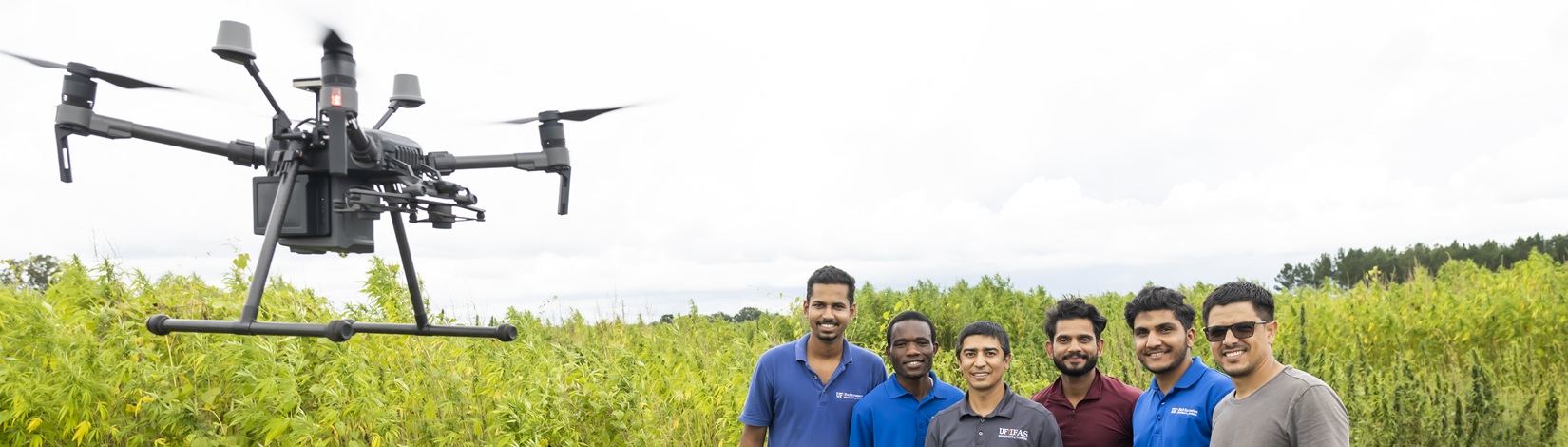 Dr. Pratap Devkota (middle, grey shirt), Weed Science, and research team operating a drone.