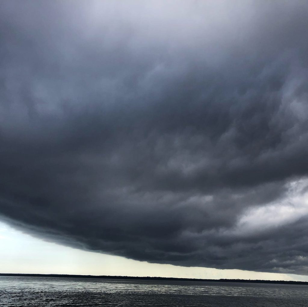 large gray storm cloud over water