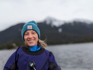 Rachel Martin, UF Grad and Professional Expedition Diver. Mountains and water in the background.