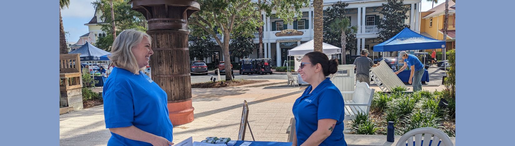 Two women speaking at a table.