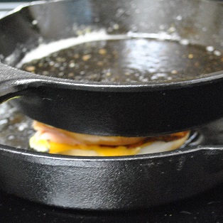 pressing sandwich with iron skillet