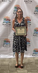 NACTA Educator Award Recipient Dr. Jaclyn Kropp poses holding her award at the 2023 NACTA annual conference