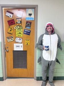 To encourage student involvement, Ag Econ Club advisor Caleb Stair dresses up in Shark Costume in front of his decorated door