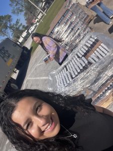 Maya outside in front of a large display of bottles, cranberry | Food Science and Human Nutrition UF/IFAS